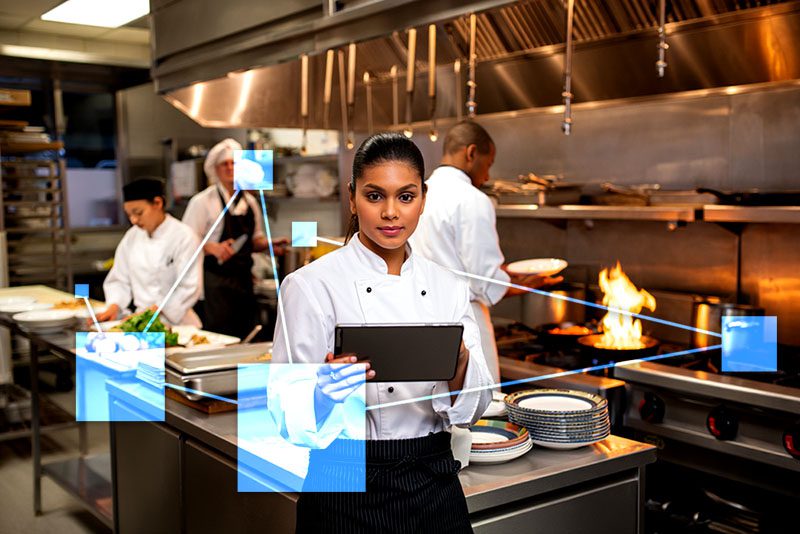 Chef managing kitchen with TVI Chef managing kitchen staff, menu and food costs with TVI directly integrated with inventory, CRM and accounting.